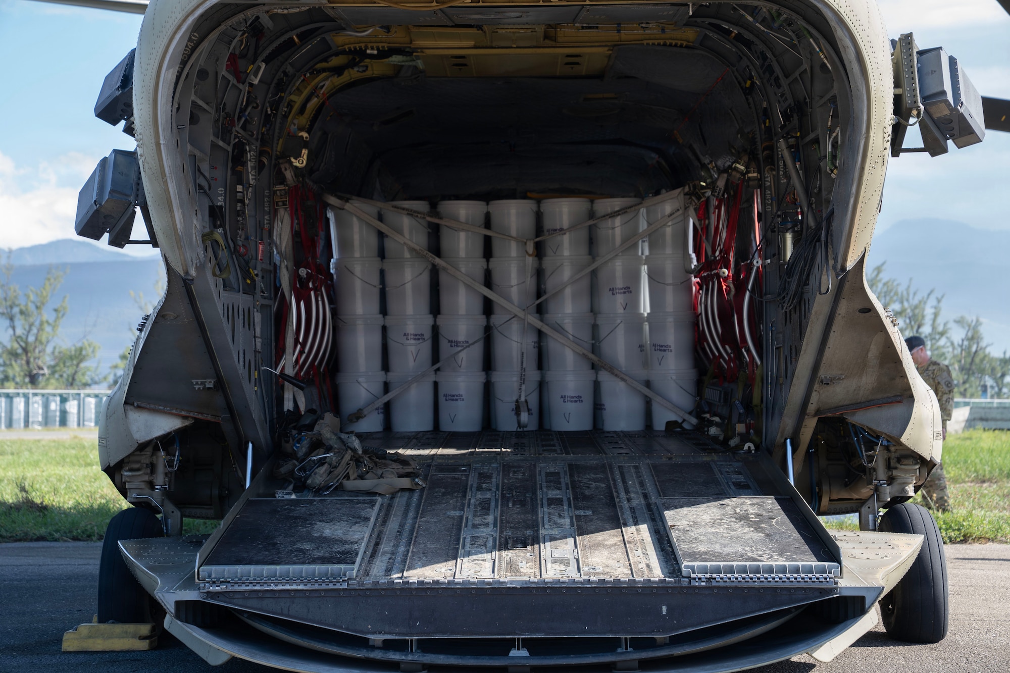 Buckets are strapped into the inside of a helicopter.