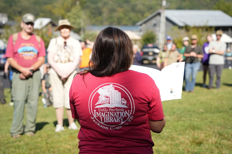 Granville, Tenn.. (Sept. 27, 2025) — Faith Henshaw, of the Dolly Parton Imagination Library Jackson County Chapter Board of Directors, reads aloud When the Storm Comes by Linda Ashman, the inaugural book featured on the new Storybook Trail at Periwinkle Trail during the dedication ceremony. (USACE photo by Noe Gonzalez)