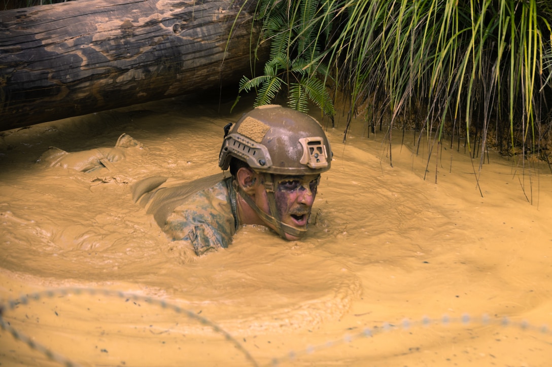 U.S. Marine Corps Staff Sgt. Jon Lizotte, a platoon sergeant with Animal Company, Battalion Landing Team 1st Battalion, 7th Marine Regiment, 31st Marine Expeditionary Unit, traverses the endurance course during the Basic Jungle Skills Course at the Jungle Warfare Training Center, Okinawa, Japan, Sept. 19, 2025. The week-long course instructed the Marines on basic jungle survival skills, tactical rope suspension techniques, and jungle warfare tactics to enhance lethality in harsh jungle environments. The 31st MEU, the Marine Corps’ only continuously forward-deployed MEU, provides a flexible and lethal force ready to perform a wide range of military operations as the premiere crisis response force in the Indo-Pacific region. (U.S. Marine Corps photo by Lance Cpl. Victor Gurrola)