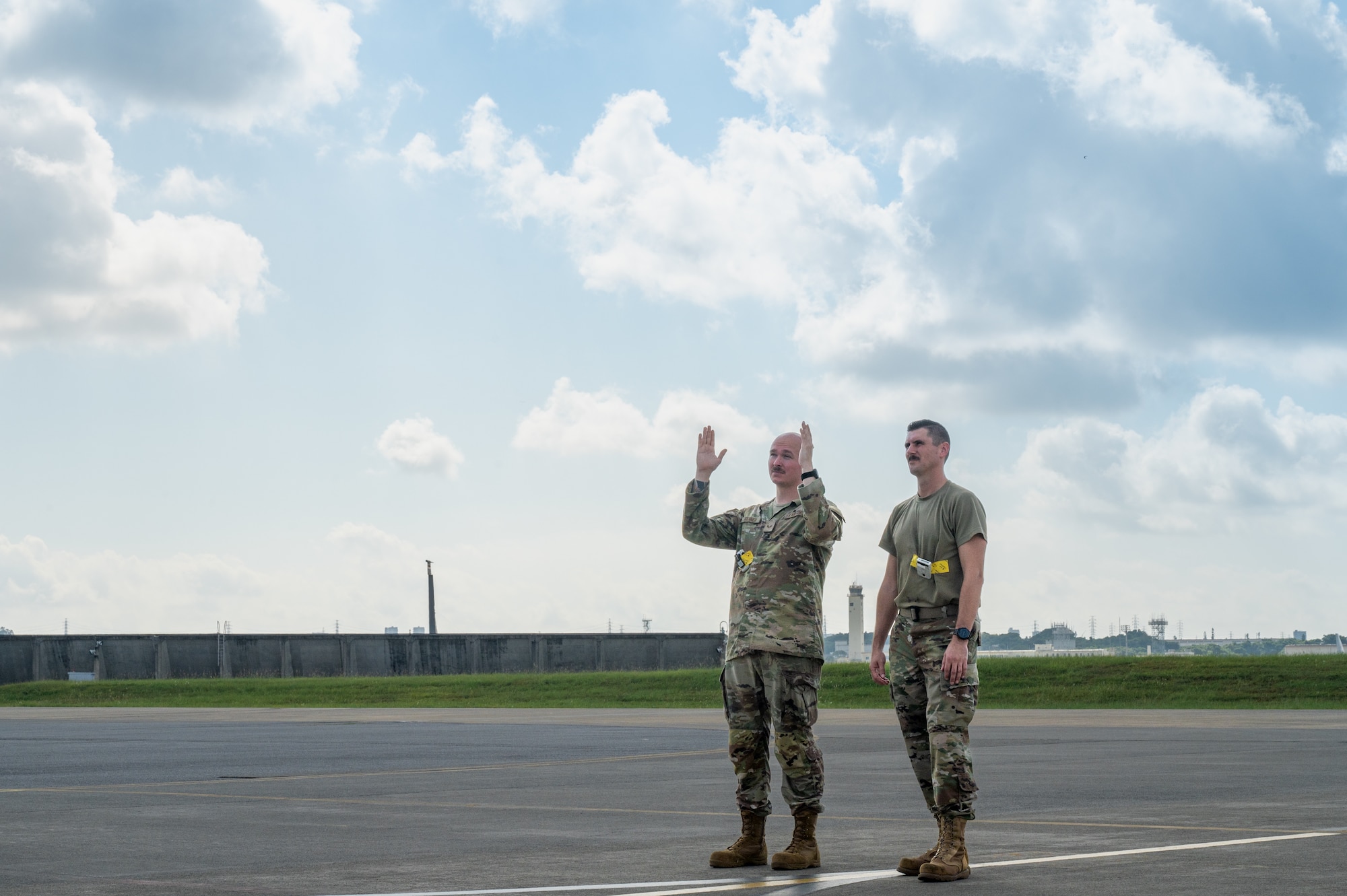 Service members simulate taxiing an aircraft.