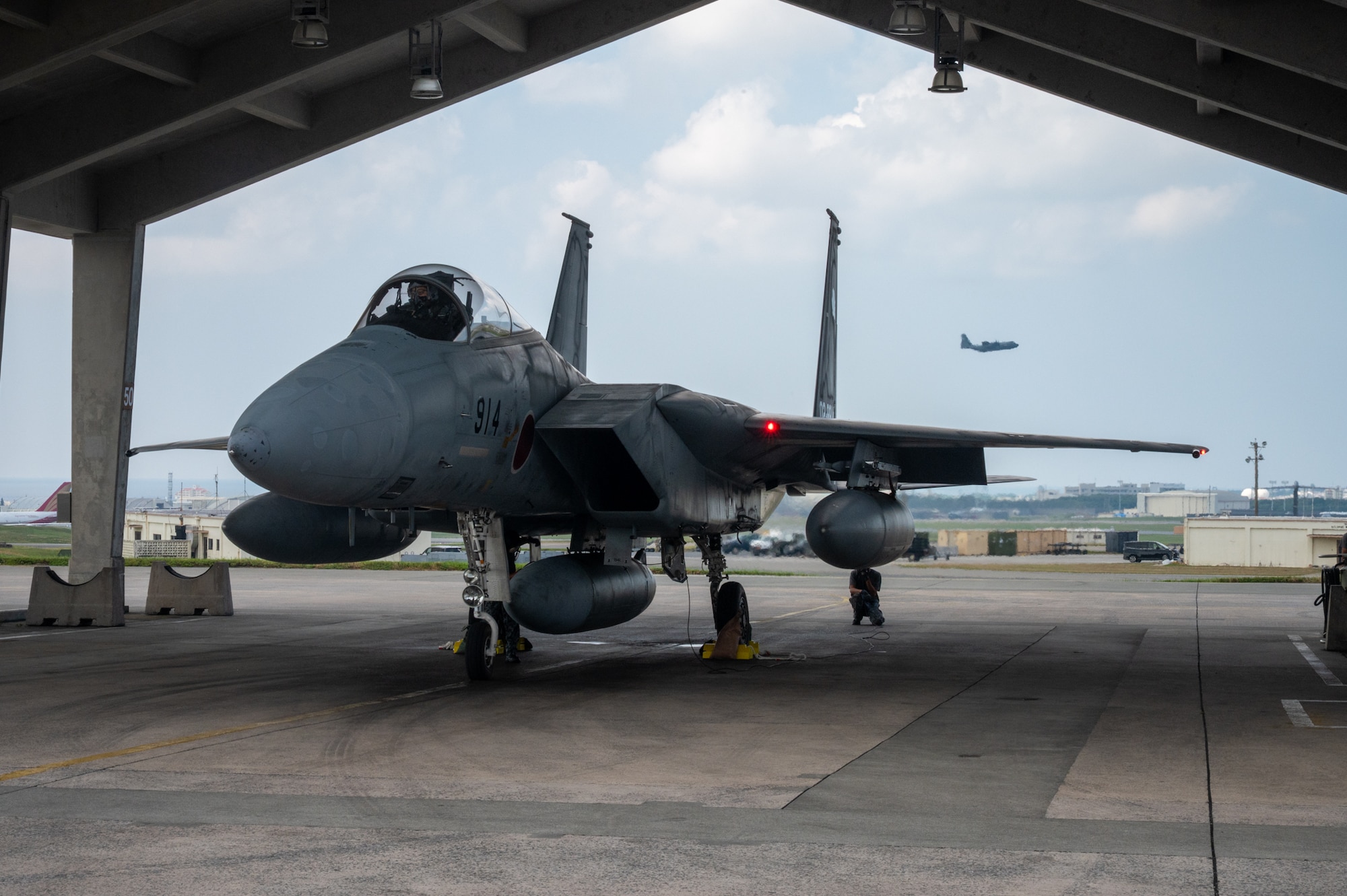 A jet sits under a hangar at Kadena Air Base.