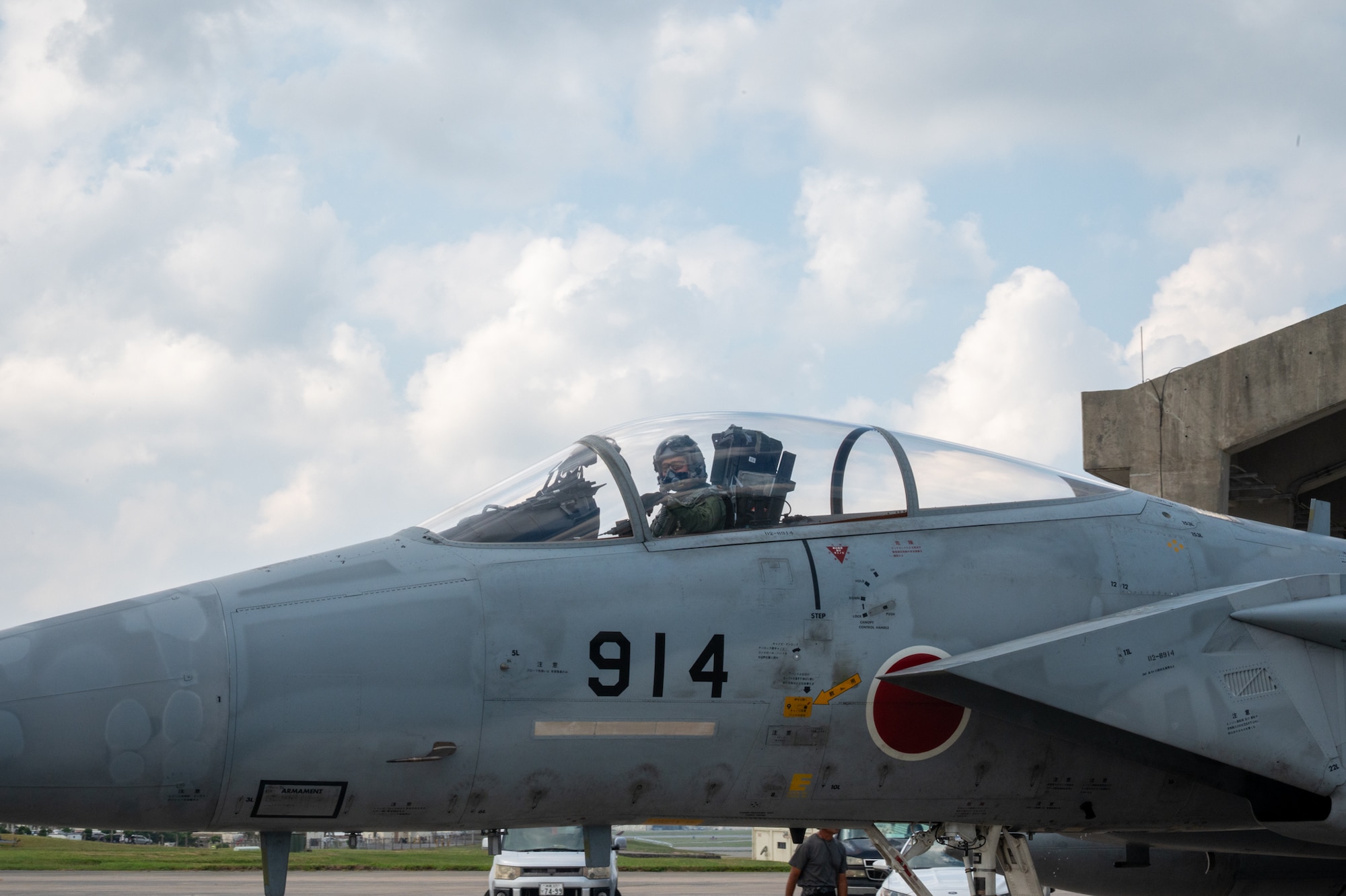 A pilot sits in a jet, preparing to take off.