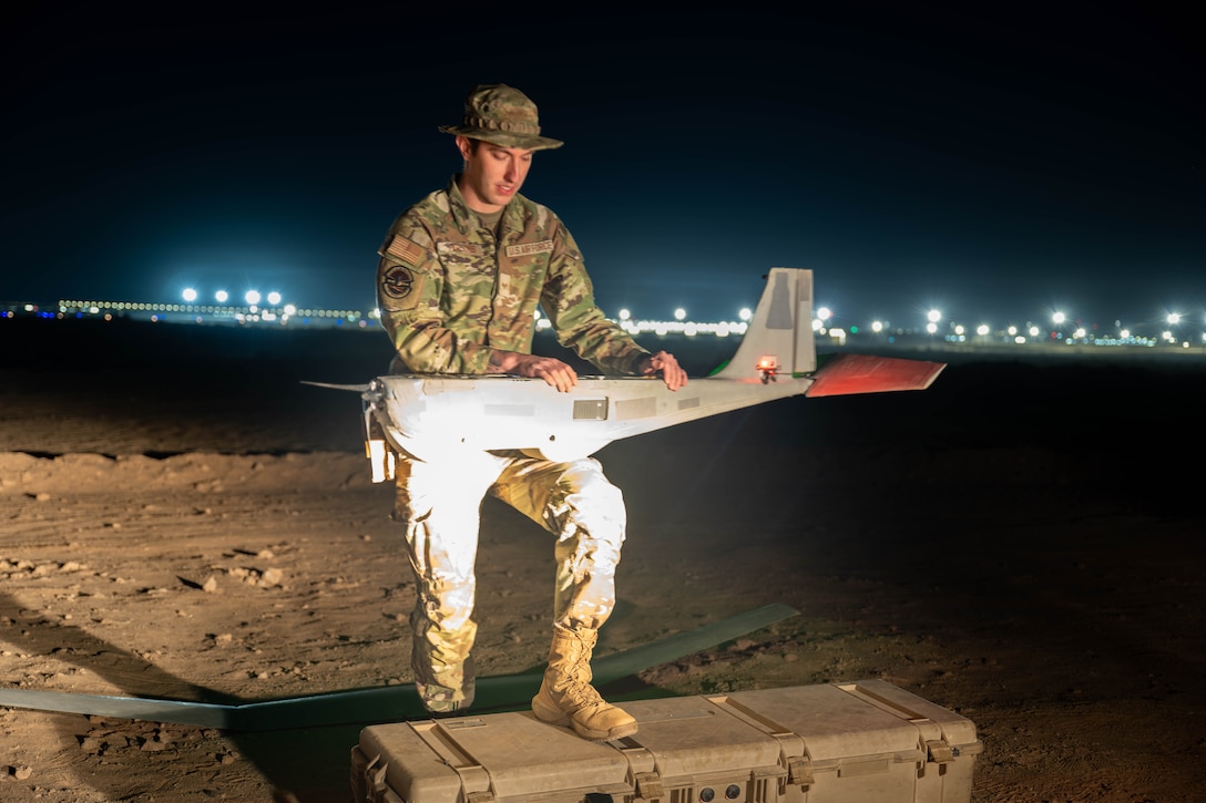 U.S. Air Force Senior Airman Jordan Parsons, 332nd Expeditionary Security Forces Squadron small unmanned aircraft systems operator, prepares an RQ-20 Bravo B “PUMA” drone for flight in the U.S. Central Command area of responsibility Oct. 31, 2025. Mid-shift SUAS operators monitor live aerial surveillance in low-light areas to bolster nighttime security. (U.S. Air Force photo by Senior Airman Kari Degraffenreed)