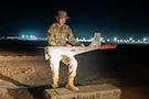 U.S. Air Force Senior Airman Jordan Parsons, 332nd Expeditionary Security Forces Squadron small unmanned aircraft systems operator, prepares an RQ-20 Bravo B “PUMA” drone for flight in the U.S. Central Command area of responsibility Oct. 31, 2025. Mid-shift SUAS operators monitor live aerial surveillance in low-light areas to bolster nighttime security. (U.S. Air Force photo by Senior Airman Kari Degraffenreed)