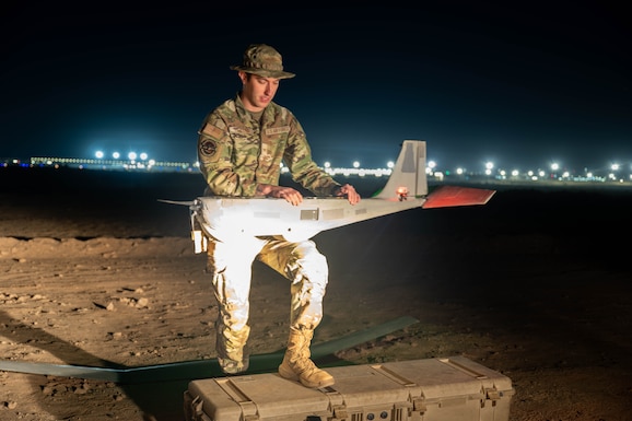 U.S. Air Force Senior Airman Jordan Parsons, 332nd Expeditionary Security Forces Squadron small unmanned aircraft systems operator, prepares an RQ-20 Bravo B “PUMA” drone for flight in the U.S. Central Command area of responsibility Oct. 31, 2025. Mid-shift SUAS operators monitor live aerial surveillance in low-light areas to bolster nighttime security. (U.S. Air Force photo by Senior Airman Kari Degraffenreed)