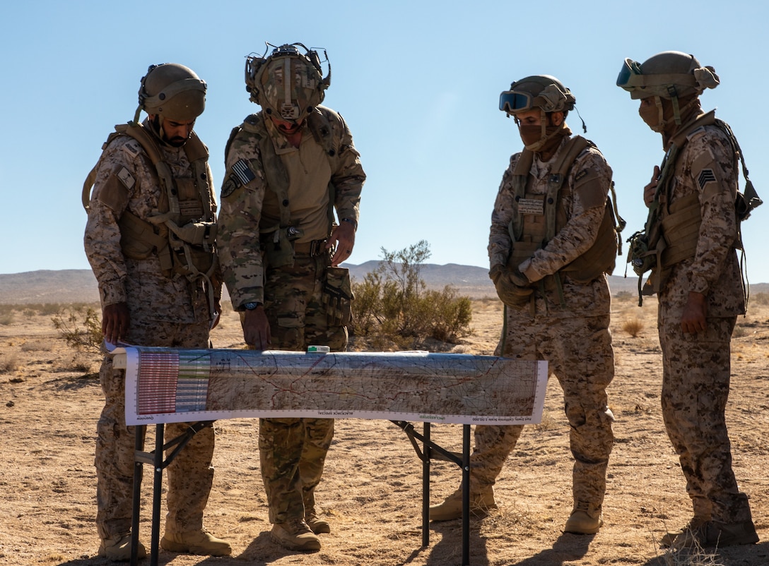 A 3rd Security Forces Assistance Brigade advisor discusses planning with soldiers of the Royal Saudi Land Forces (RSLF) as they prepare to conduct force-on-force operations for the first time at the National Training Center during Rotation 26-02 at Fort Irwin, Calif., Nov. 4, 2025. Partnering with U.S. Army Central, the RSLF will integrate with 2nd Brigade, 1st Cavalry Division to improve interoperability and operational effectiveness in a tough, realistic environment. (U.S. Army photo by Staff Sgt. Devon Jones)