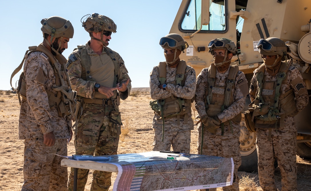 A 3rd Security Forces Assistance Brigade advisor discusses planning with soldiers of the Royal Saudi Land Forces (RSLF) as they prepare to conduct force-on-force operations for the first time at the National Training Center during Rotation 26-02 at Fort Irwin, Calif., Nov. 4, 2025. Partnering with U.S. Army Central, the RSLF will integrate with 2nd Brigade, 1st Cavalry Division to improve interoperability and operational effectiveness in a tough, realistic environment. (U.S. Army photo by Staff Sgt. Devon Jones)