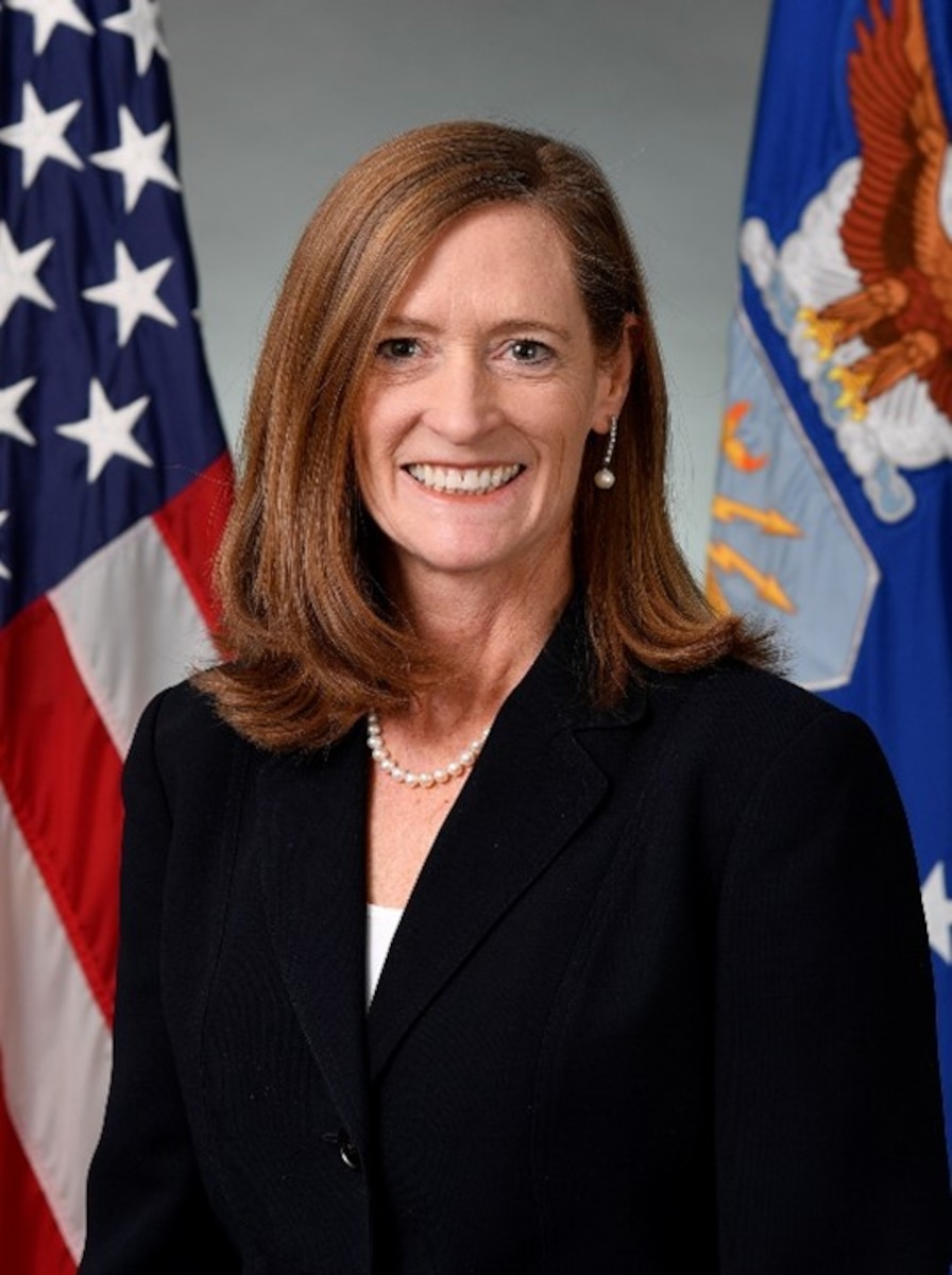 A Department of War civilian stands for a portrait.