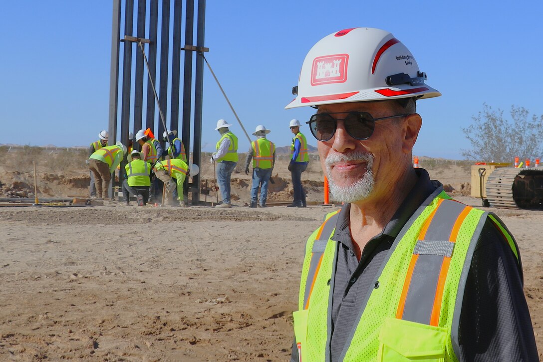 Michael Tuttle, lead project manager for the U.S. Army Corps of Engineers South Pacific Border Task Force, monitors barrier construction at the BMGR-1 project site near Yuma, Arizona, Oct. 15. USACE is replacing permanent border barriers along the southern border of the U.S. at the direction of the U.S. Army by the Secretary of War, in response to the presidential national emergency declaration dated Jan. 20, 2025, authorizing the use of Section 2803 of Title 10, U.S. Code. (Photo by Robert DeDeaux USACE PAO)