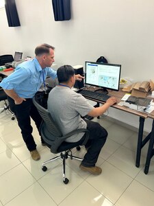 MAJ Eads (left) and SPC Campos (right) analyze mosquitos utilizing the AI assisted IDX system for disease surveillance at African Lion 2025.