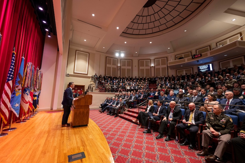 The secretary of war speaks to an audience.