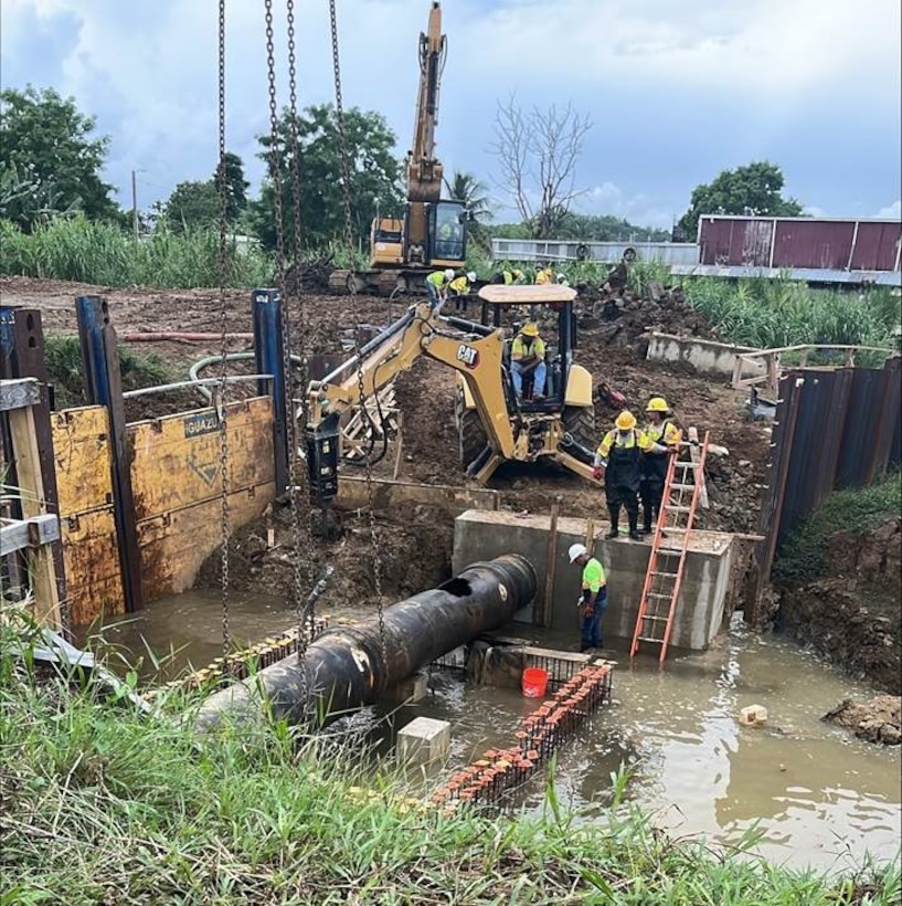 Workers relocate a critical water line in San Juan during the Roosevelt Avenue Bridge replacement