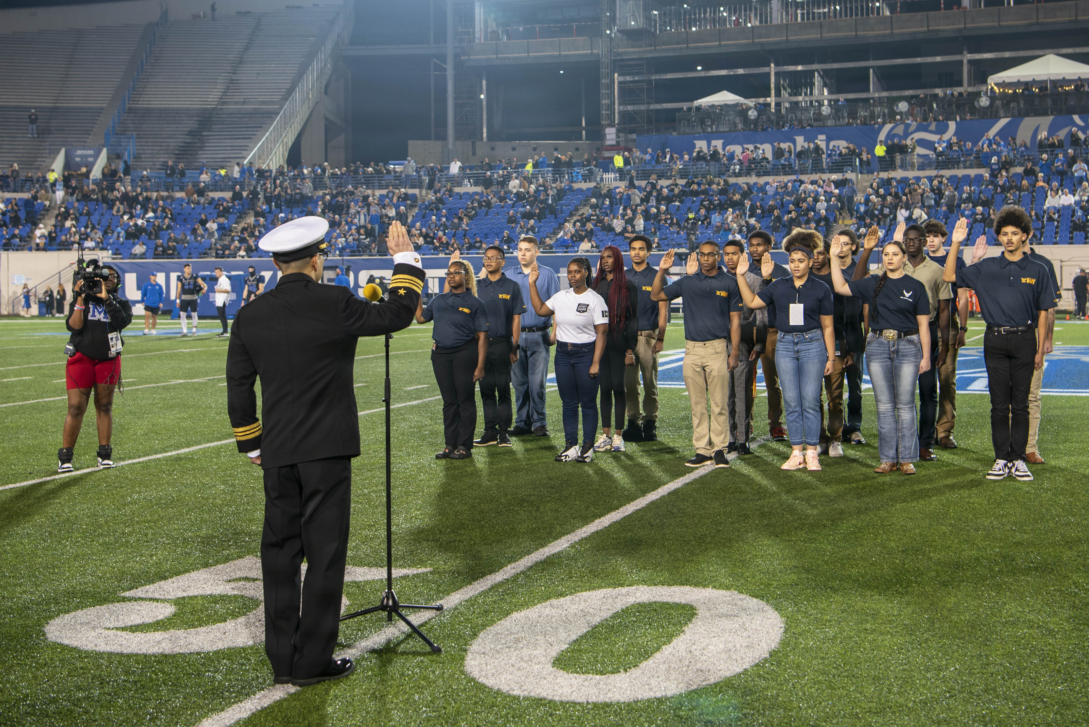 Lt. Cmdr. Matthew Faber, Commanding Officer of Memphis MEPS, prepares to administer the oath of enlistment at the Memphis Tigers vs. Tulane Green Wave game on November 7. NTAG Nashville oversees 46 recruiting stations across seven states.