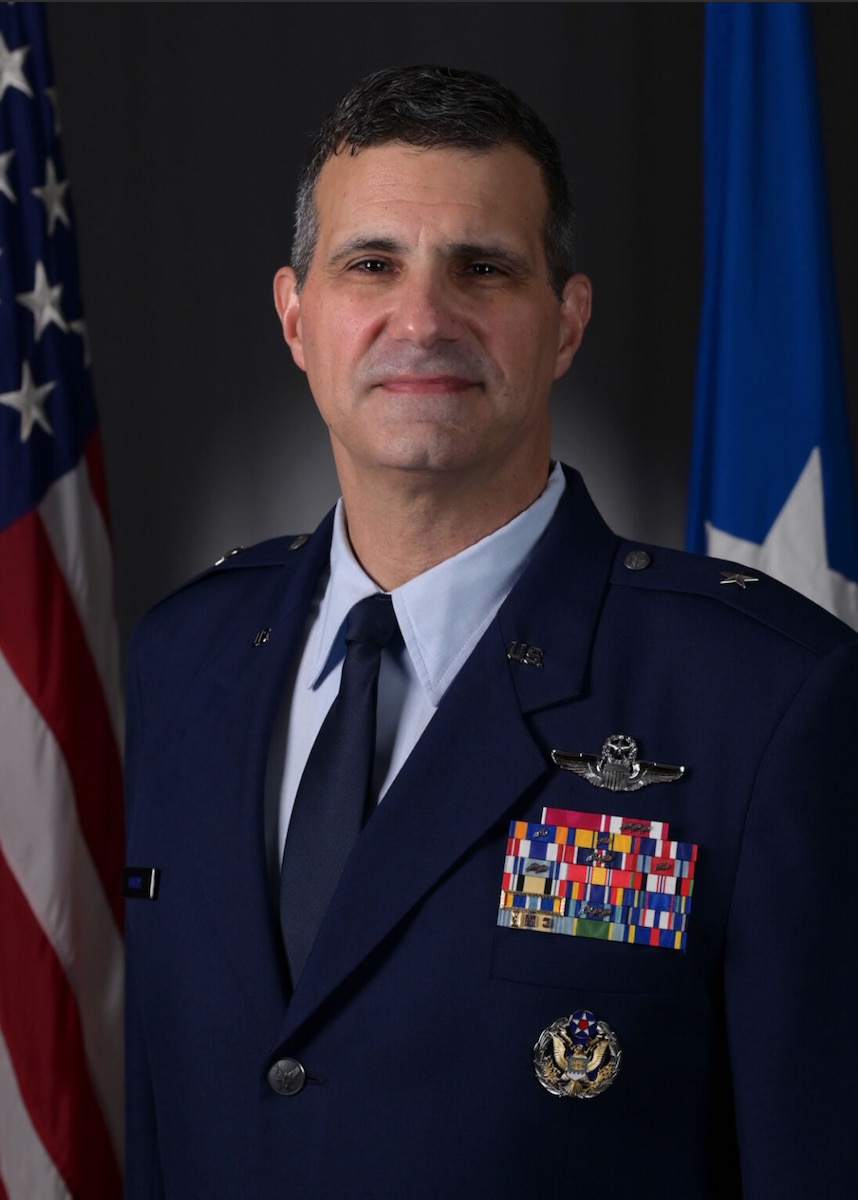 A military member stands for a portrait.