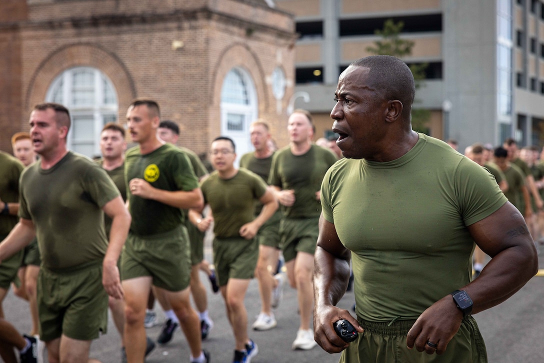 U.S. Marine Corps Sgt. Maj. Kabiru Labaran, sergeant major, Headquarters Battalion, Marine Forces Reserve, calls cadence during the annual birthday motivational run celebrating the 250th birthday of the U.S. Marine Corps, in New Orleans, Nov. 7, 2025. The run started at the Marine Corps Support Facility New Orleans and traveled along the Mississippi River ending back at MCSF. The run celebrates the history of the Marine Corps and creates esprit de corps and comradery among Marines. (U.S. Marine Corps photo by Lance Cpl. Juan Diaz)
