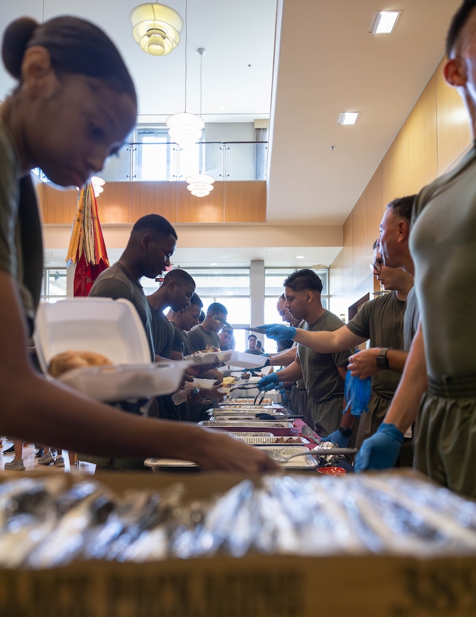 U.S. Marines and sailors with Marine Forces Reserve and Marine Forces South serve food in a warrior’s breakfast after an annual birthday motivational run celebrating the 250th birthday of U.S. Marine Corps, in New Orleans, Nov. 7, 2025. The run started at the Marine Corps Support Facility New Orleans and traveled along the Mississippi River ending back at MCSF. The run celebrates the history of the Marine Corps and creates esprit de corps and comradery among Marines. (U.S. Marine Corps photo by Lance Cpl. Priscilla Flores)