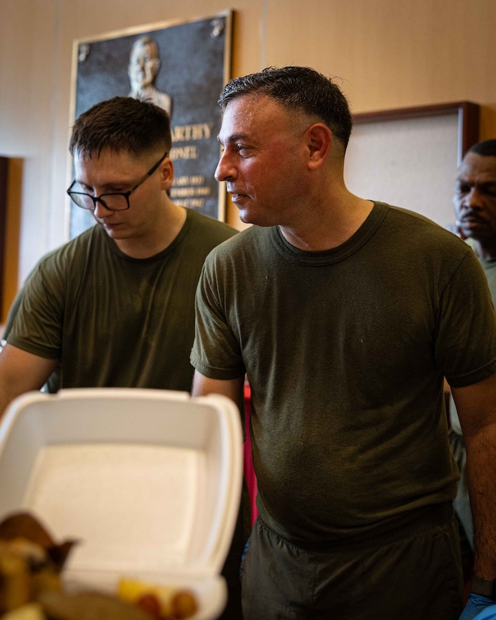 U.S. Marine Corps Col. Anthony Sferrazza, commanding officer, Headquarters Battalion, Marine Forces Reserve, serves food during a warrior’s breakfast after an annual birthday motivational run celebrating the 250th birthday of the U.S. Marine Corps, in New Orleans, Nov. 7, 2025. The run started at the Marine Corps Support Facility New Orleans and traveled along the Mississippi River ending back at MCSF. The run celebrates the history of the Marine Corps and creates esprit de corps and comradery among Marines. (U.S. Marine Corps photo by Lance Cpl. Juan Diaz)