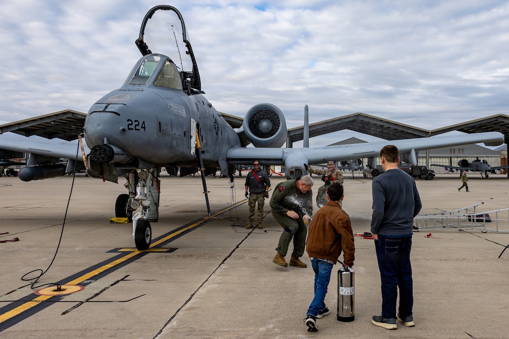 U.S. Air Force Lt. Col. Bart Ward, an A-10C Thunderbolt II aircraft pilot, assigned to the 107th Fighter Squadron, Michigan Air National Guard, is sprayed by his sons to celebrate his final A-10 mision at Selfridge Air National Guard Base, Michigan, Nov. 1, 2025. Deemed a, "fini" flight, a pilots final mission is honored in a tradition dating back to World War II.