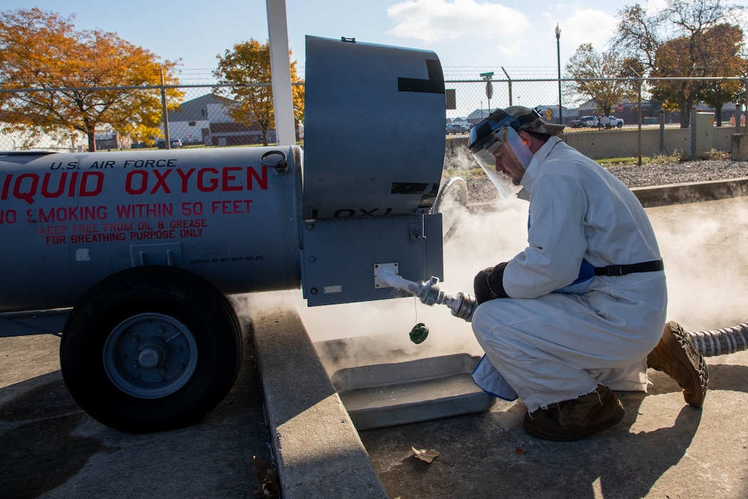 U.S. Air Force Tech. Sgt. Nicholas Bousquette, fuels management journeyman, 127th Logistics Readiness Squadron, fuels flight, Michigan National Guard, removes a hose off a 50-gallon issuing tank at Selfridge Air National Guard Base, Michigan, Nov. 2, 2025. This oxygen goes on aircraft for pilots to breathe at high altitudes, keeping missions safe and effective.