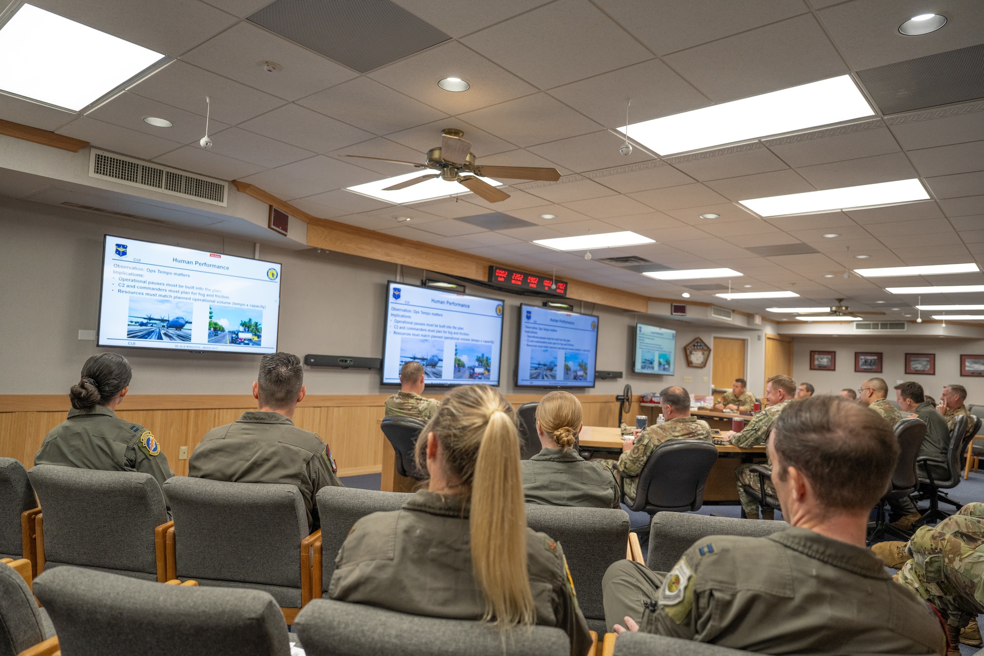 Airmen sit around a conference table