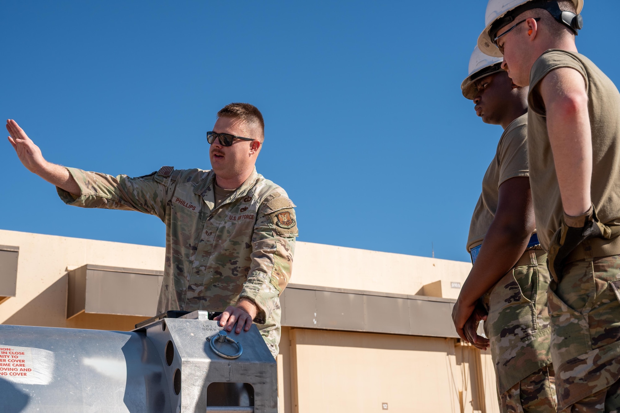 U.S. Air Force Staff Sgt. Aaron Phillips, left, 7th Munitions Squadron conventional maintenance supervisor, instructs Airmen on missile-loading procedures during exercise Death Strike 25-03 at Dyess Air Force Base, Texas, Sept. 22, 2025. The exercise sharpened unit readiness through rapid-response raining designed to replicate real-world contingency operations. (U.S. Air Force photo by Airman 1st Class Adrien Tran)