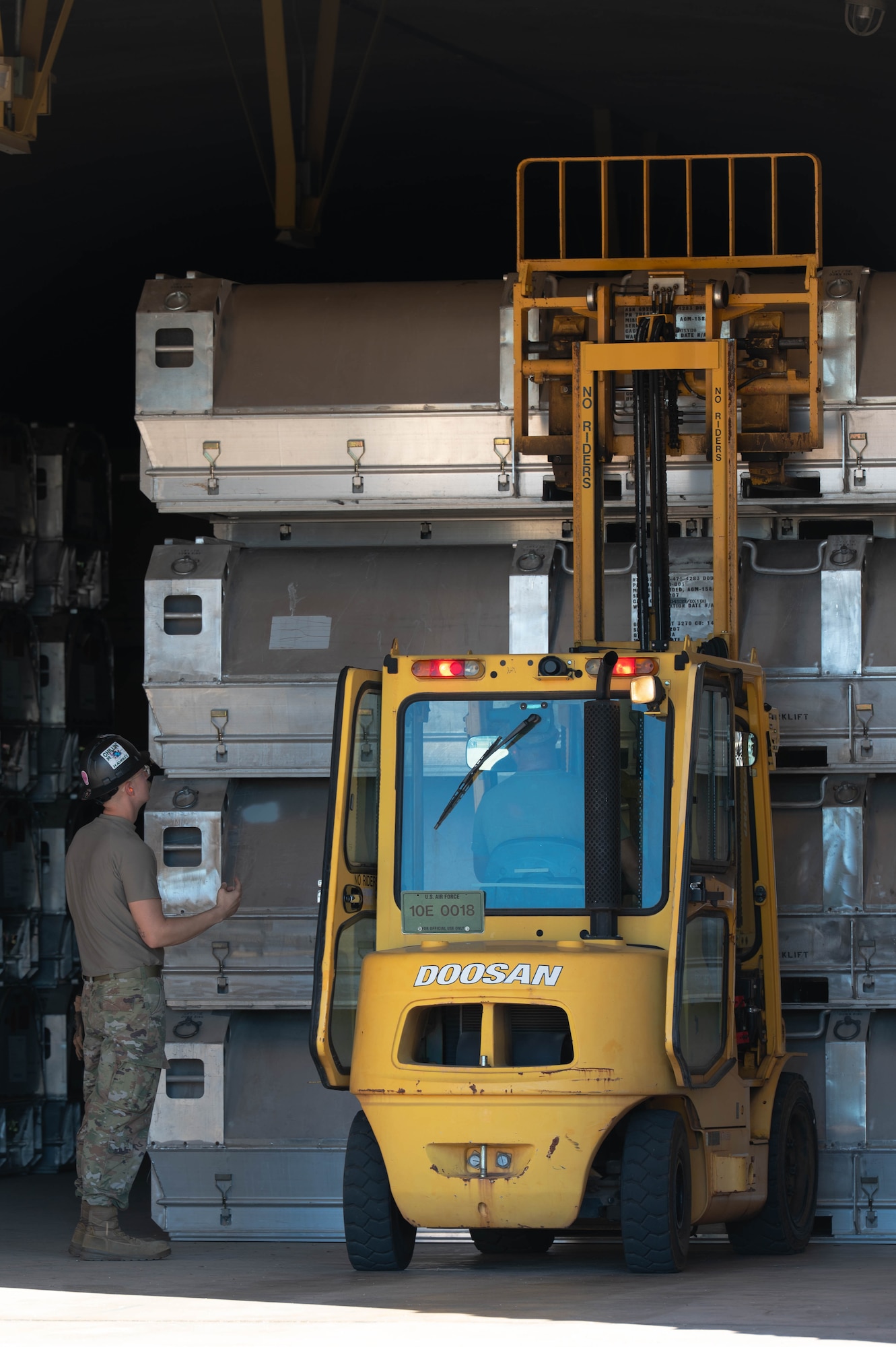 U.S. Air Force Senior Airmen Daniel McNulty and Cody Garza, 7th Munitions Squadron conventional maintenance crew chiefs, move inert Joint Air-to-Surface Standoff Missiles during exercise Death Strike 25-03 at Dyess Air Force Base, Texas, Sept. 22, 2025. The JASSMs were moved during the exercise to evaluate time efficiency from storage to flight-ready status. (U.S. Air Force photo by Airman William Neal)