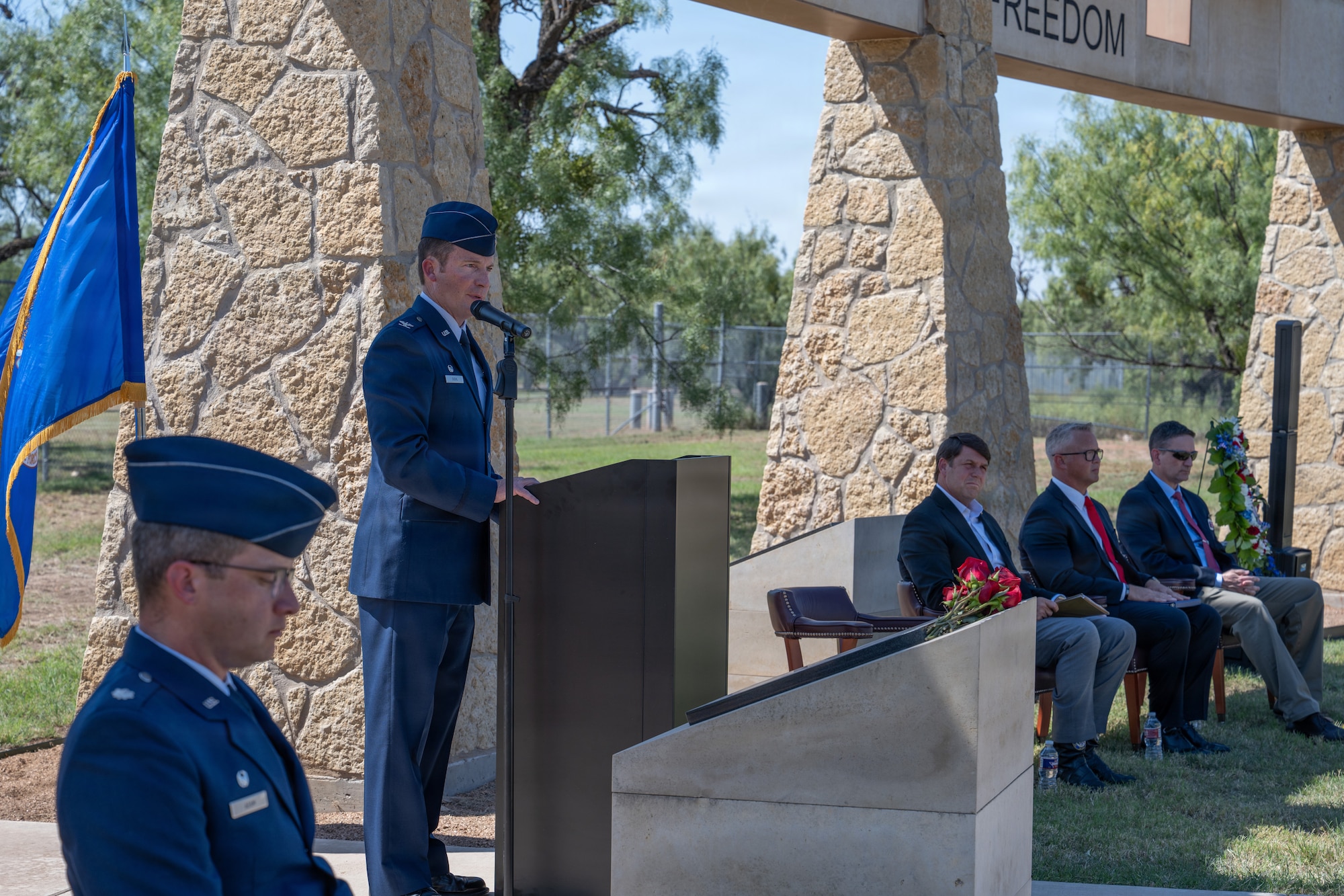 Gold Star family members of Airmen lost in TORQE 62 gather around a commemorative plaque