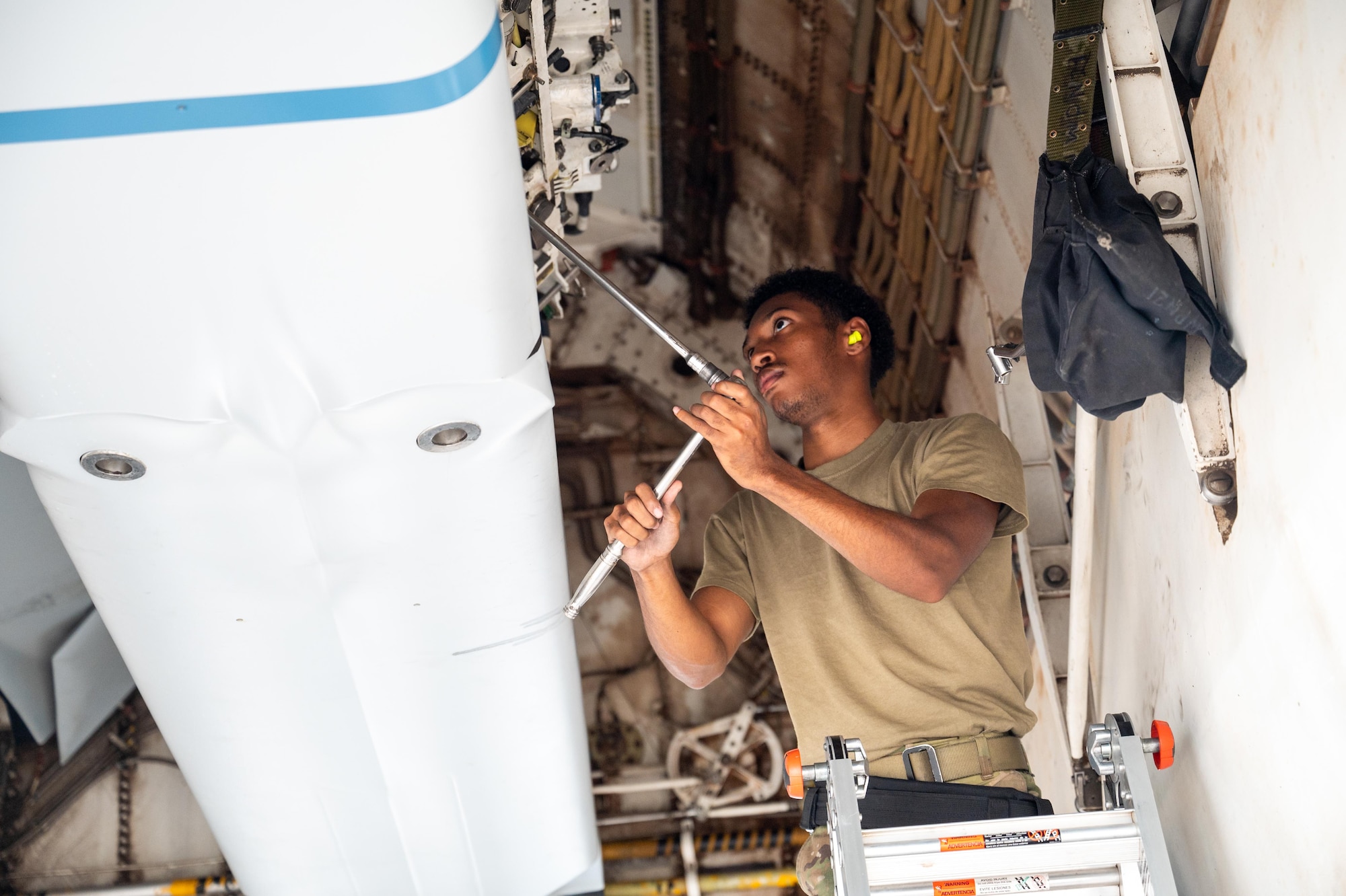 U.S. Air Force Airman 1st Class Ryan Valentine, 28th Bomber Generation Squadron aircraft armament systems specialist, fastens bolts onto a multi-purpose rotary launcher in a B-1B Lancer during exercise Death Strike 25-03 at Dyess Air Force Base, Texas, Sept. 23, 2025. During the exercise the 28th BGS performed dual crew loading operations to reduce overall load time. (U.S. Air Force photo by Airman 1st Class Adrien Tran)