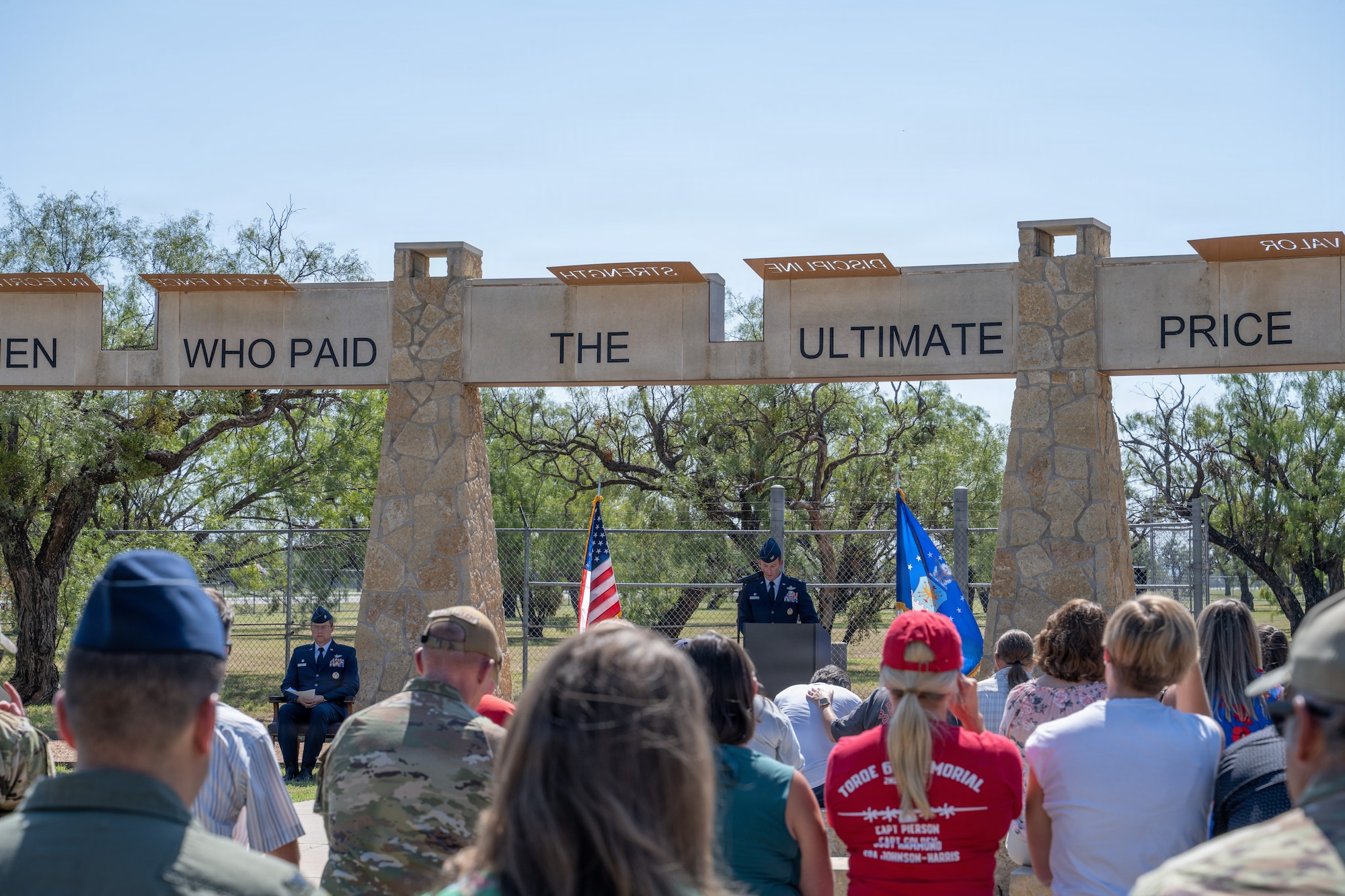 Gold Star family members of Airmen lost in TORQE 62 gather around a commemorative plaque