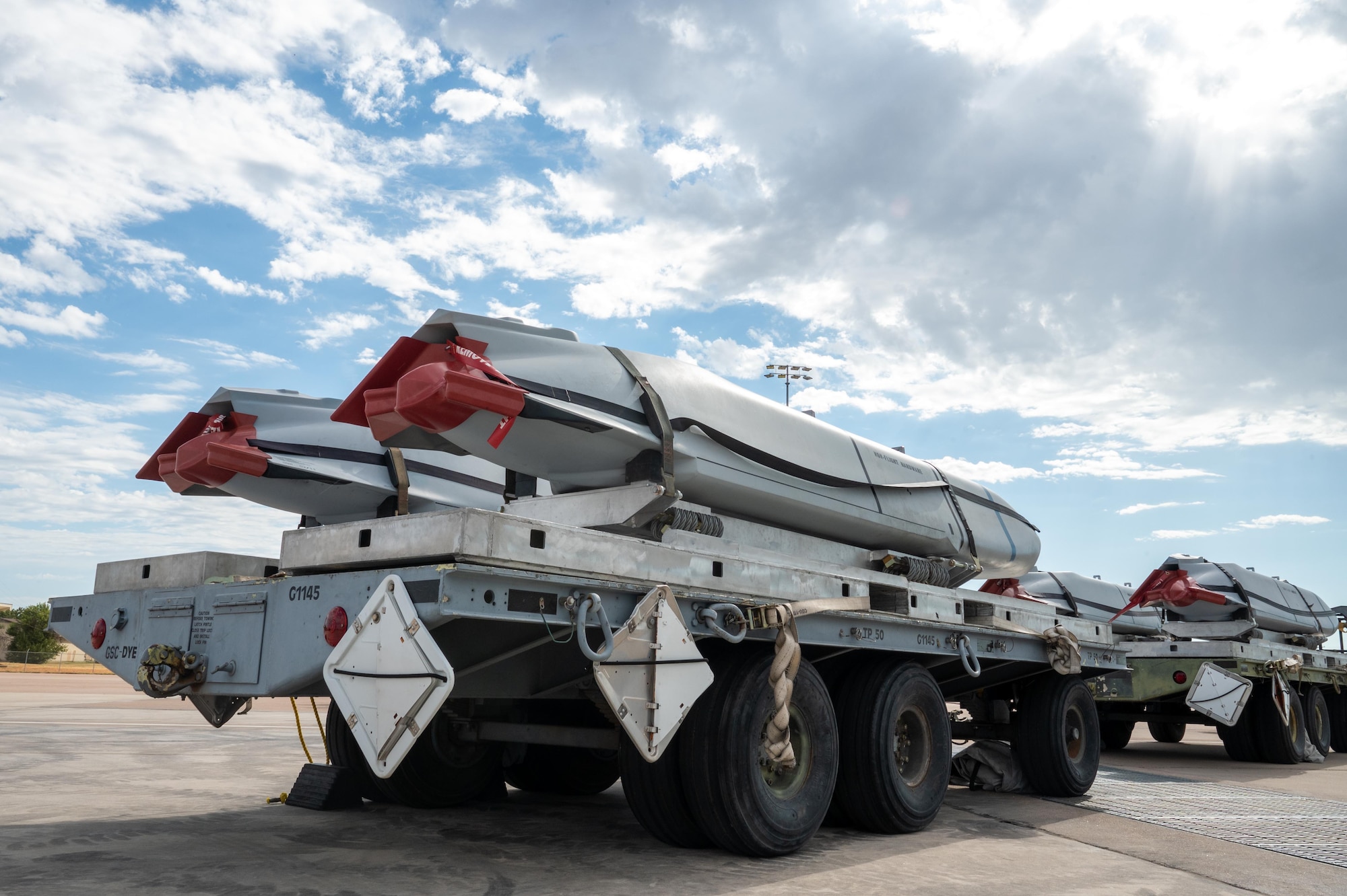 Joint Air-to-Surface Standoff Missiles prepared by the 7th Munitions Squadron await loading onto a B-1B Lancer during exercise Death Strike 25-03 at Dyess Air Force Base, Texas, Sept. 23, 2025. The exercise included large-scale handling, re- warehousing and generation of the entire JASSM stockpile, the break-out of standoff munitions for transport and the coordinated delivery of munitions to the flightline. (U.S. Air Force photo by Airman 1st Class Adrien Tran)