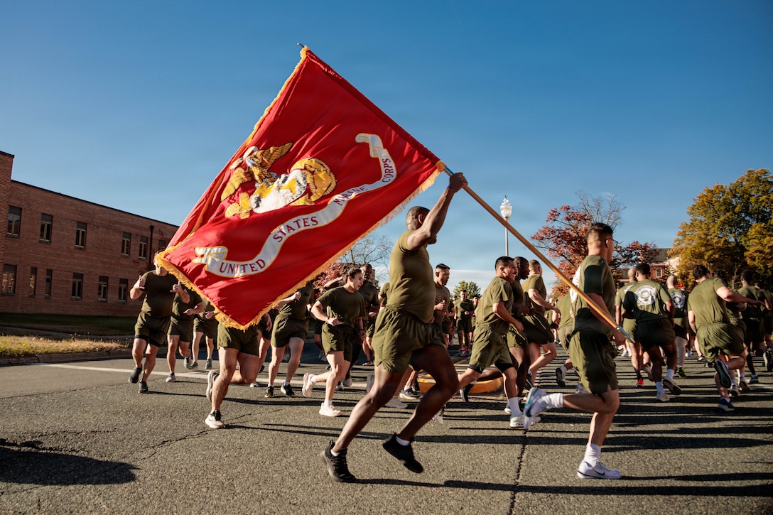 U.S. Marines run in formation to celebrate the 250th Marine Corps Birthday on MCB Quantico, Nov. 6, 2025. Marines from across the installation participated in a motivational run emphasizing esprit de corps and physical readiness showcasing unity and pride in their shared heritage. (U.S. Marine Corps photo by Sgt. Dean Gurule)