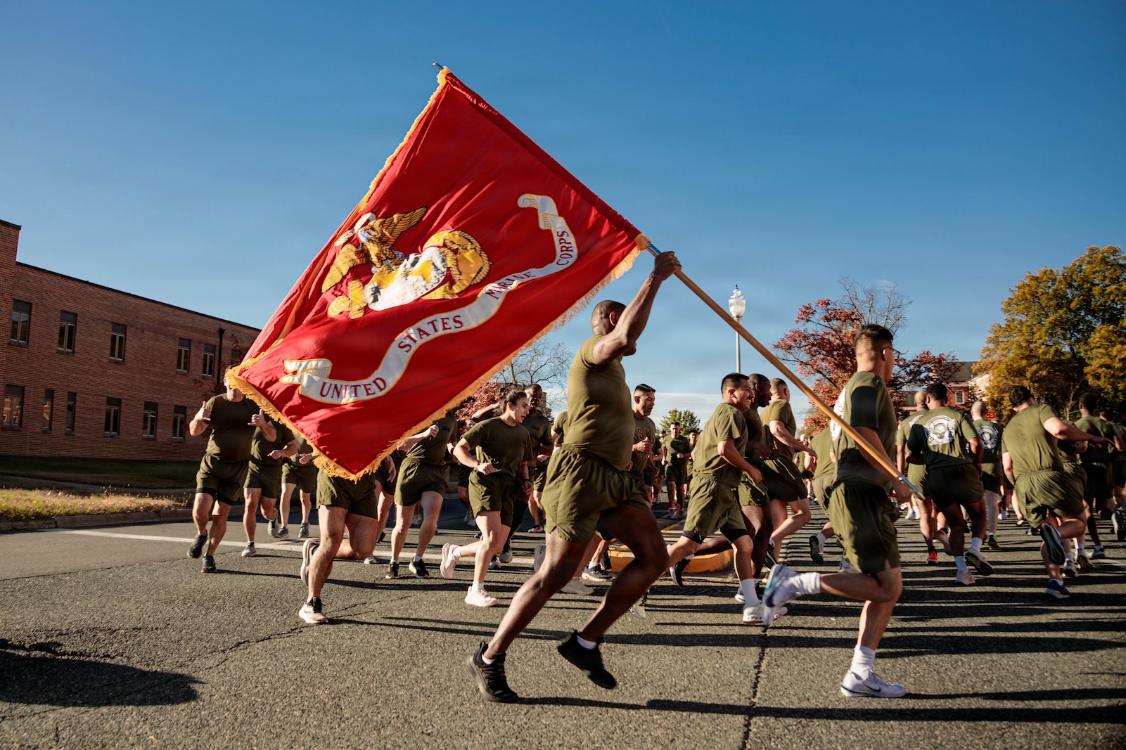 U.S. Marines run in formation to celebrate the 250th Marine Corps Birthday on MCB Quantico, Nov. 6, 2025. Marines from across the installation participated in a motivational run emphasizing esprit de corps and physical readiness showcasing unity and pride in their shared heritage. (U.S. Marine Corps photo by Lance Cpl. Jeffery Stevens)