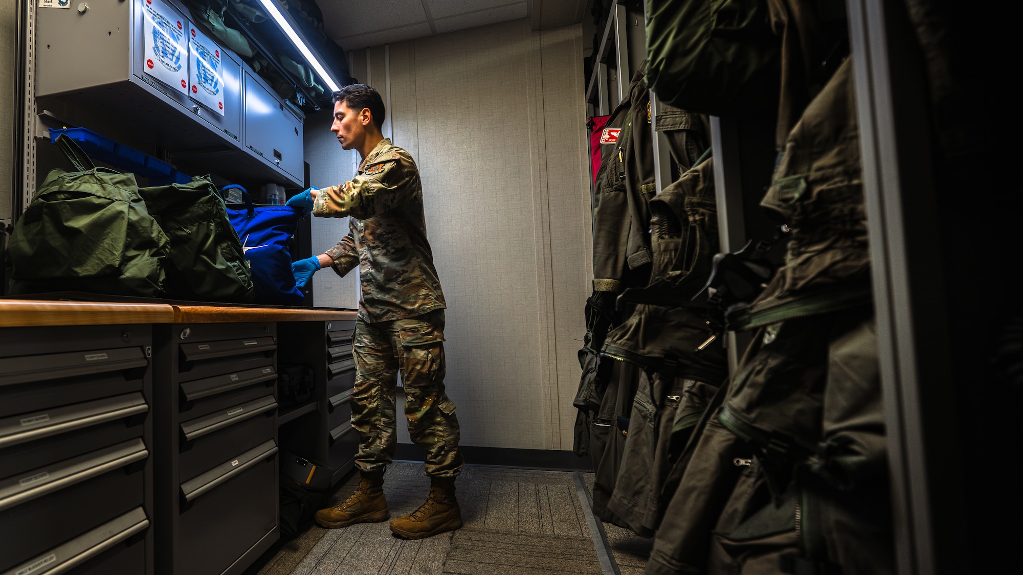 Airman inspects pilot gear