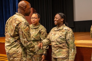SSgt Anaya Hunter, 787th Civil Engineer Squadron airman dorm leader, is coined by Chief Master Sgt. Nicholas Conner, 87th Air Base Wing command chief during an NCO Call at Joint Base McGuire-Dix-Lakehurst, N.J. on September 29, 2025.