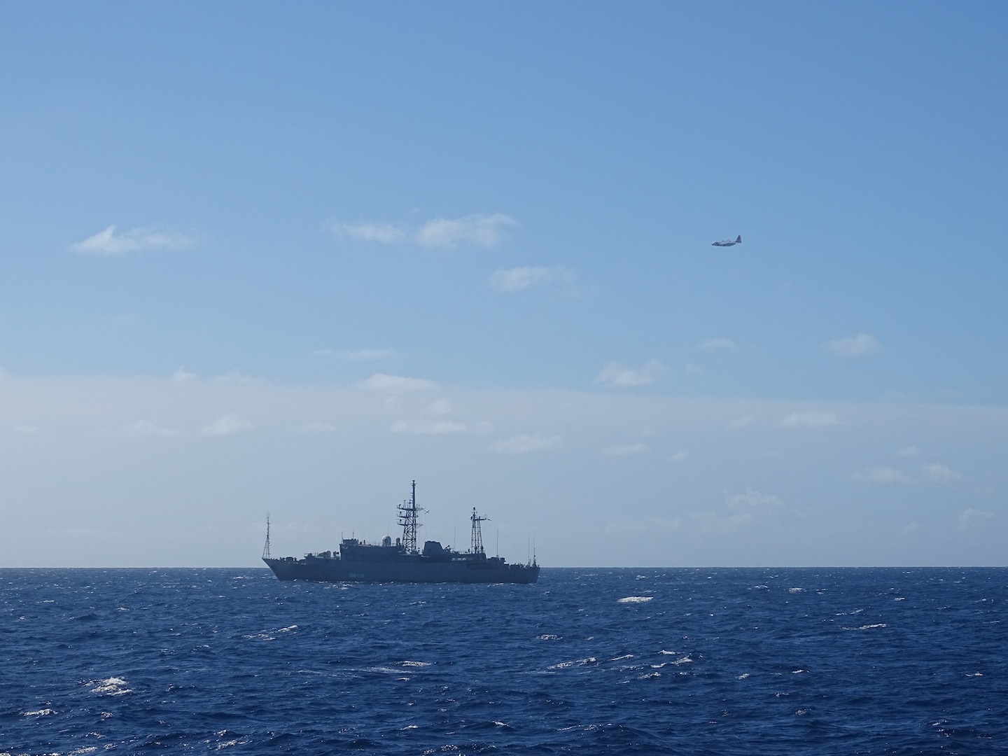A Coast Guard HC-130 Hercules airplane crew from Air Station Barbers Point monitors a Russian military vessel approximately 15 nautical miles south of Oahu Oct. 29, 2025. Coast Guard personnel are monitoring the vessel’s activities near U.S. territorial waters, which extend to 12 miles offshore. (U.S. Coast Guard photo, courtesy Cutter William Hart)