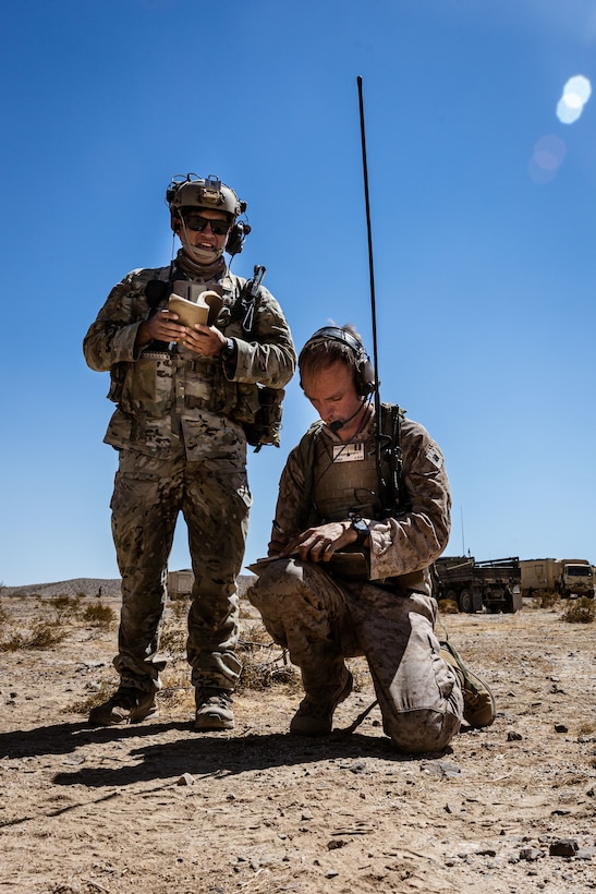 U.S. Airman Staff Sgt. Daniel Sanchez, left, a Joint Terminal Attack Controller assigned to 12th Combat Training Squadron, 57th Operations group and U.S. Marine Corps Capt. Luke Dalton, a team leader assigned to 1st Air Naval Gunfire Liaison Company, 1 Marine Expeditionary Force Information Group, calls close air support at National Training Center on Fort Irwin, California, Sept. 14, 2025. National Training Center exercise focuses on joint readiness through bilateral interoperability and strengthening partnerships in an all-domain environment. (U.S. Marine Corps photo by Cpl. Peyton Kahle)
