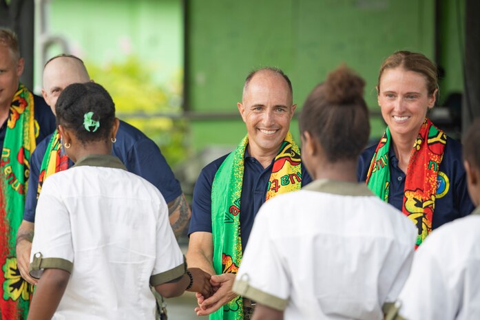 Capt. Mark B. Stefanik, mission commander of Pacific Partnership 2025, is presented with a lavalava by the students of Santo East School in Luganville, Vanuatu, Nov. 10.