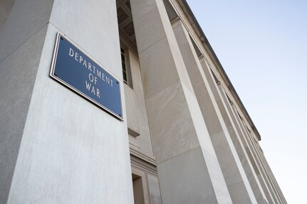 A plaque on a wall reads "Department of War."