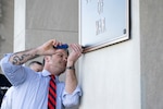 Secretary of War Pete Hegseth finishes the installation of a War Department plaque at the River Entrance in front of the Pentagon, Nov. 13, 2025.