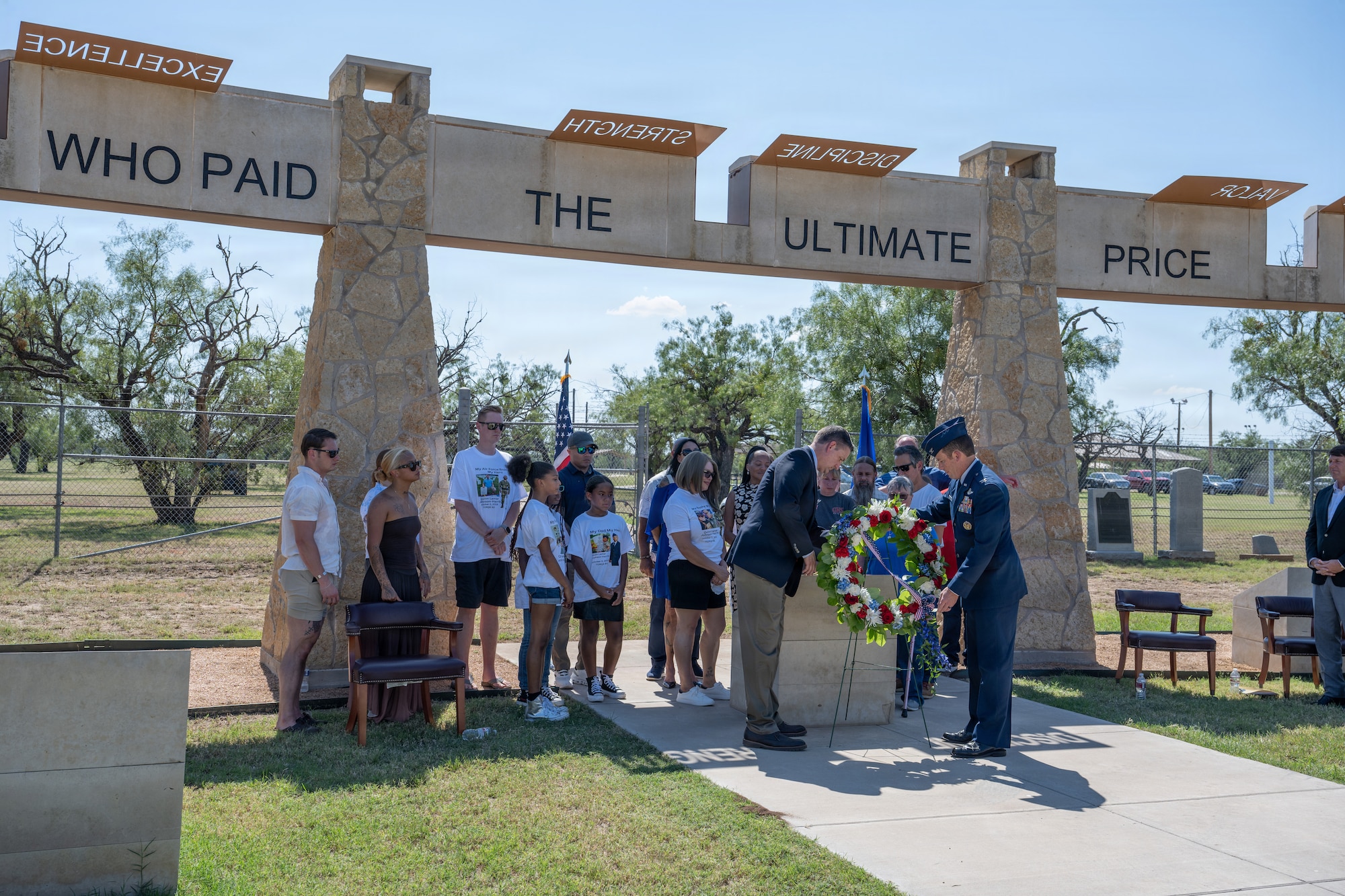 Gold Star family members of Airmen lost in TORQE 62 gather around a commemorative plaque