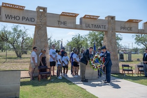 Gold Star family members of Airmen lost in TORQE 62 gather around a commemorative plaque