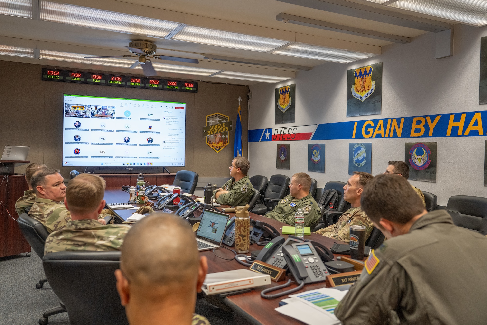 Airmen sit around a conference table