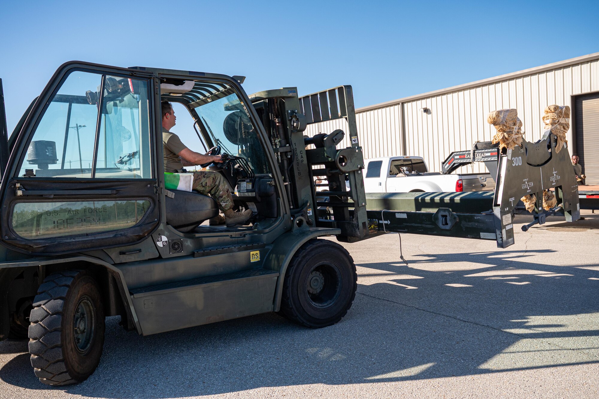 U.S. Air Force Staff Sgt. Zakkary Bunting, 7th Munitions Squadron aircraft armament systems technician, places a load launch adapter onto a trailer during exercise Death Strike 25-03 at Dyess Air Force Base, Texas, Sept. 22, 2025. The exercise tested Airmen’s ability to sustain large-scale munitions generation and meet combat-ready timeliness under simulated wartime conditions. (U.S. Air Force photo by Airman 1st Class Adrien Tran)