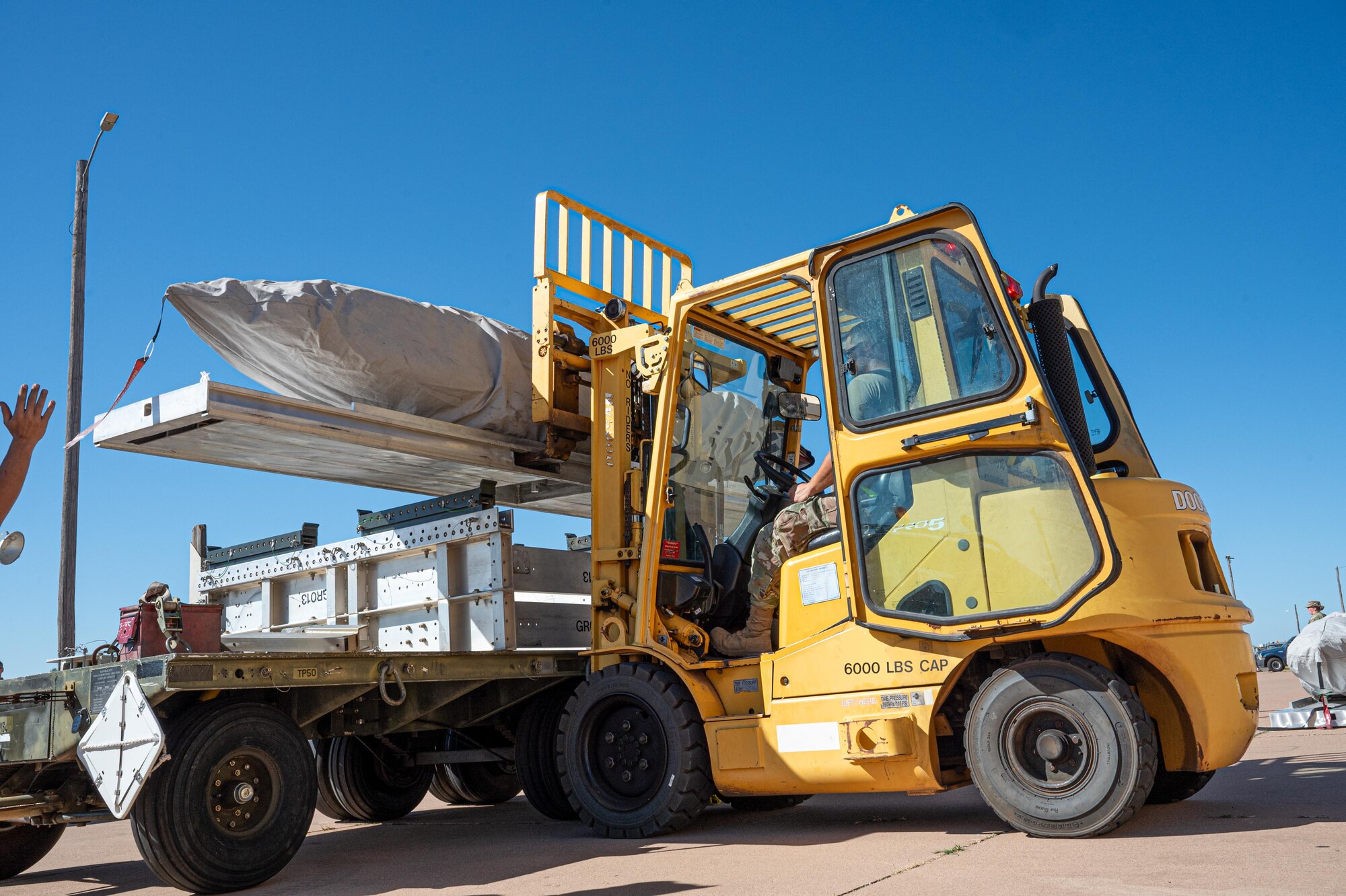 U.S. Air Force Airmen assigned to the 7th Munitions Squadron load Joint Air-to-Surface Standoff Missiles onto trailers during exercise Death Strike 25-03 at Dyess Air Force Base, Texas, Sept. 22, 2025. The JASSM’s precision-guided, long- range design enables the B-1B Lancer to strike targets while keeping crews outside of enemy threat zones. (U.S. Air Force photo by Airman 1st Class Adrien Tran)
