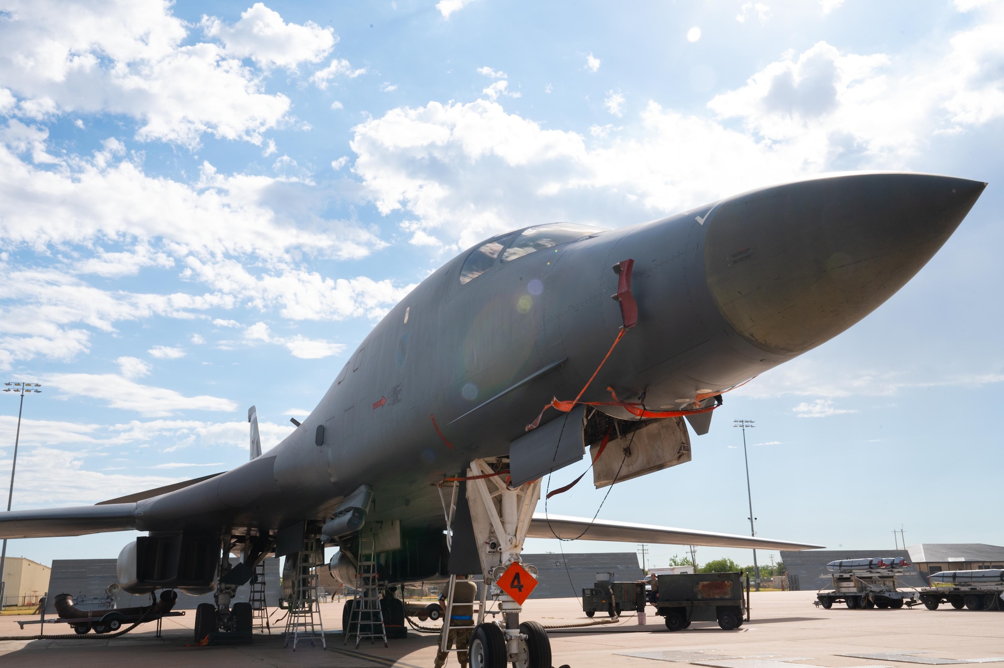 U.S. Air Force Airmen assigned to the 28th Bomber Generation Squadron load a B-1B Lancer with munitions during exercise Death Strike 25-03 at Dyess Air Force Base, Texas, Sept. 23, 2025. During the exercise the 28th BGS performed dual crew loading operations to reduce overall load time. (U.S. Air Force photo by Airman 1st Class Adrien Tran)
