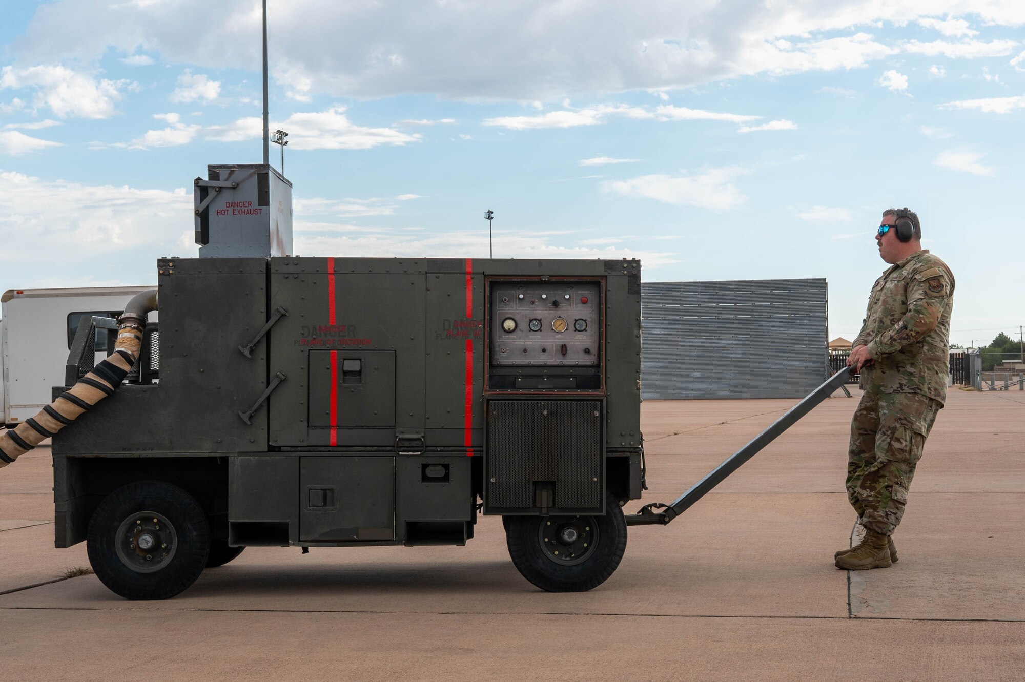 U.S. Air Force Tech. Sgt. Sean Piotrowski, 28th Bomber Generation Squadron weapons expediter, moves a Gas Turbine Air Start Unit during exercise Death Strike 25-3 at Dyess Air Force Base, Texas, Sept. 23, 2025. During the exercise the 28th BGS loaded inert JASSMs onto B-1B Lancers, refining procedures to improve sortie generation speed. (U.S. Air Force photo by Airman William Neal)