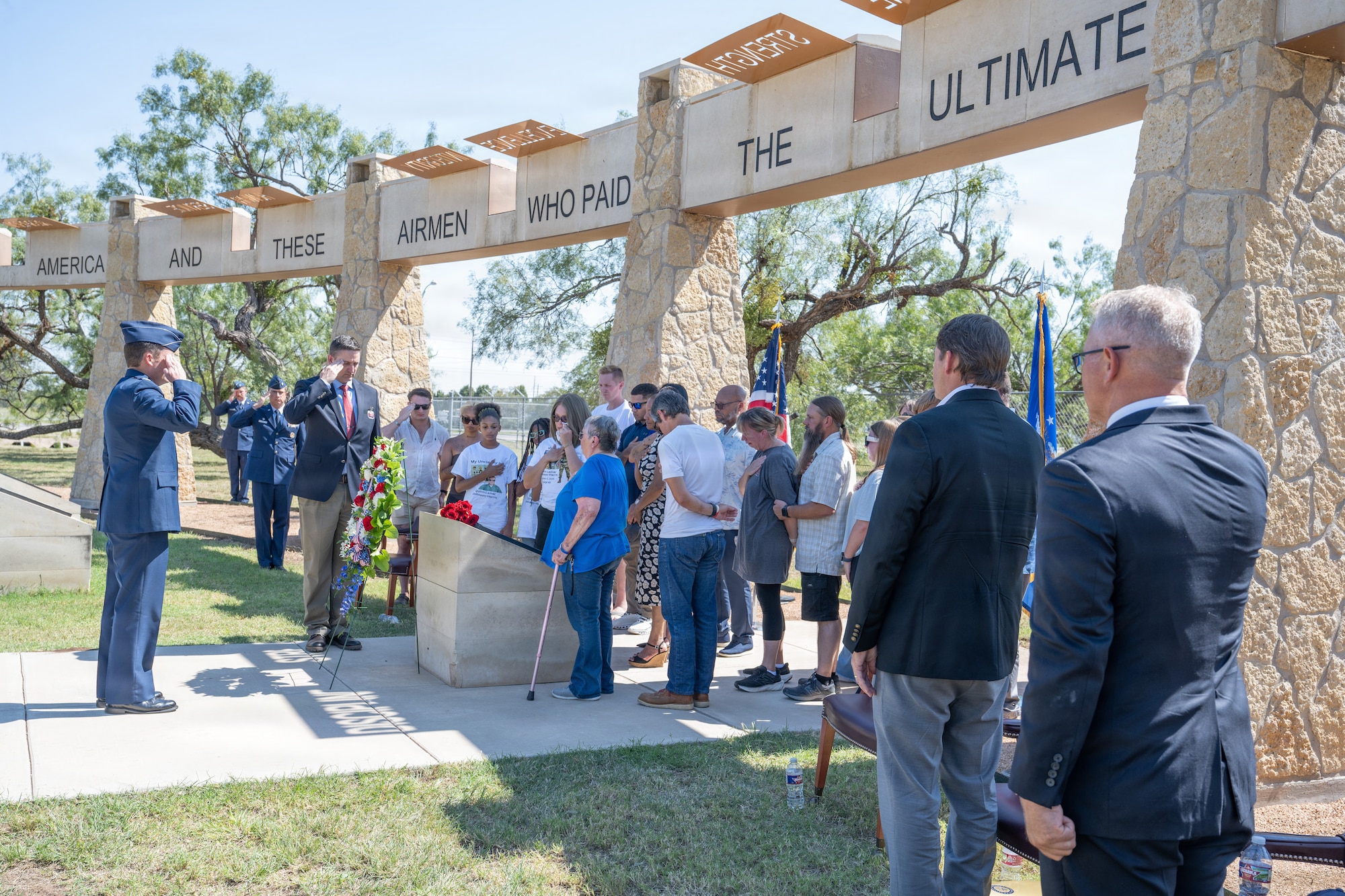 Gold Star family members of Airmen lost in TORQE 62 gather around a commemorative plaque