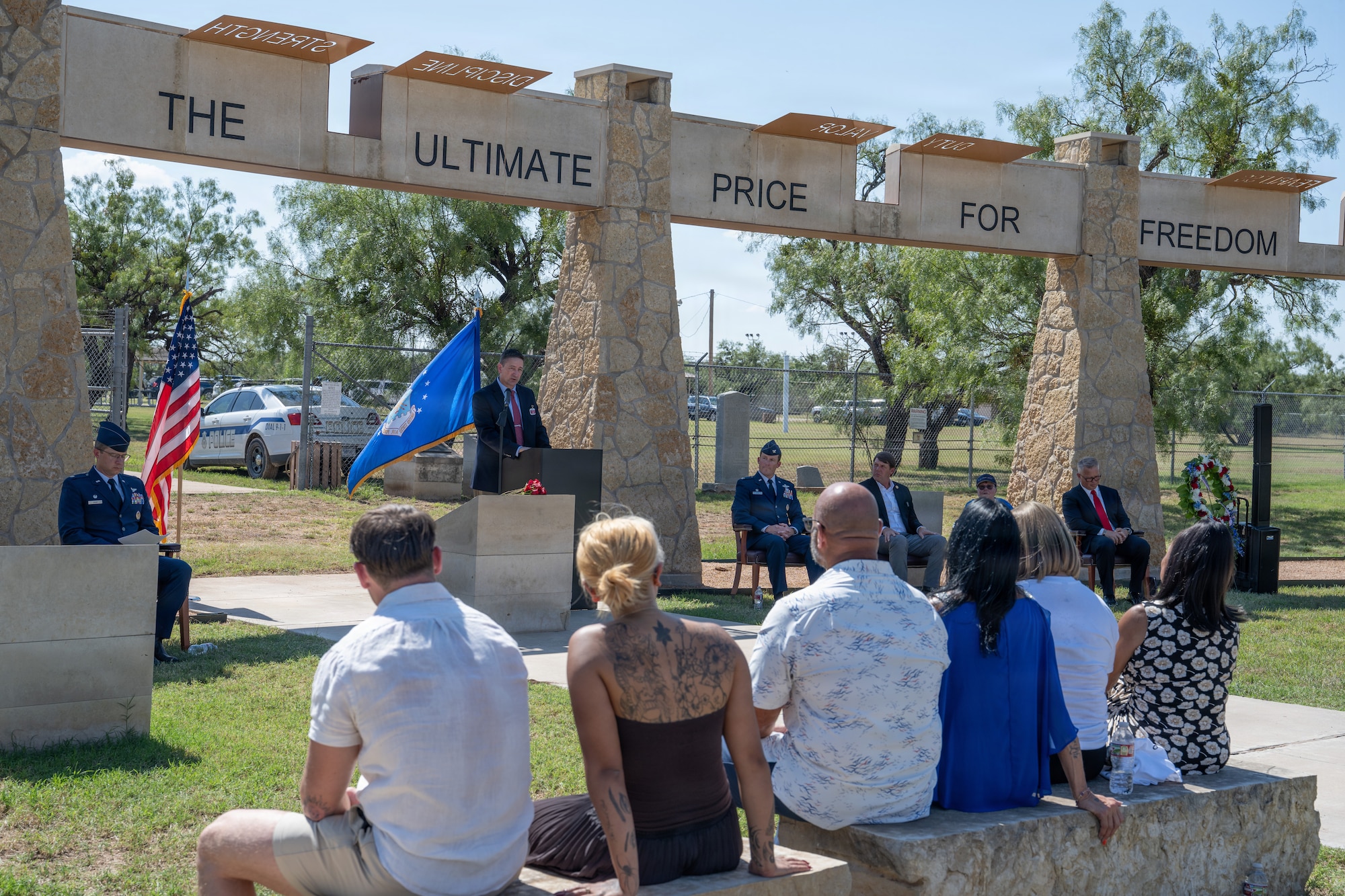 Gold Star family members of Airmen lost in TORQE 62 gather around a commemorative plaque