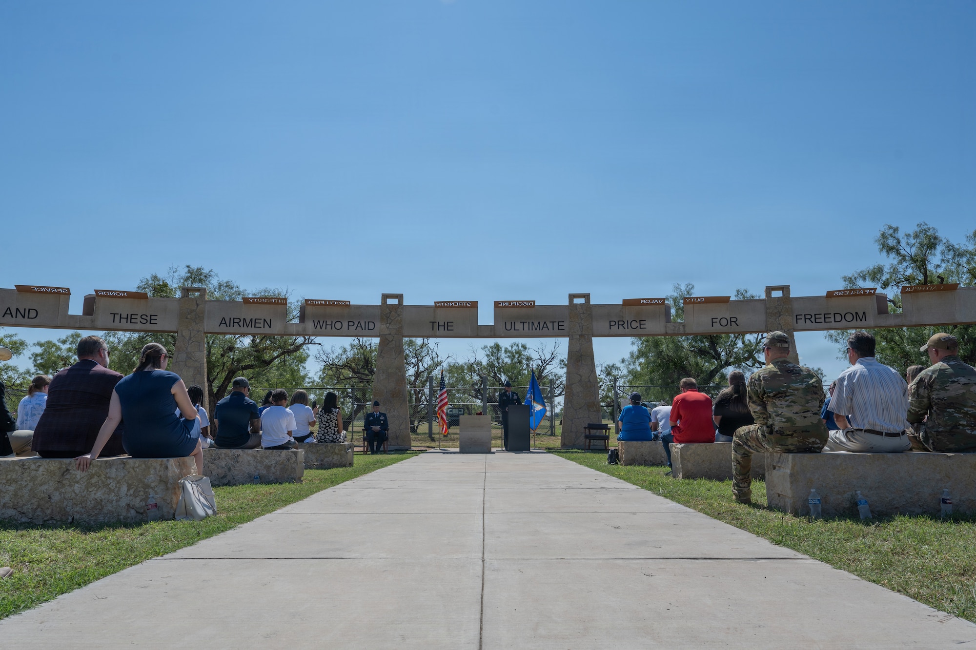 Gold Star family members of Airmen lost in TORQE 62 gather around a commemorative plaque