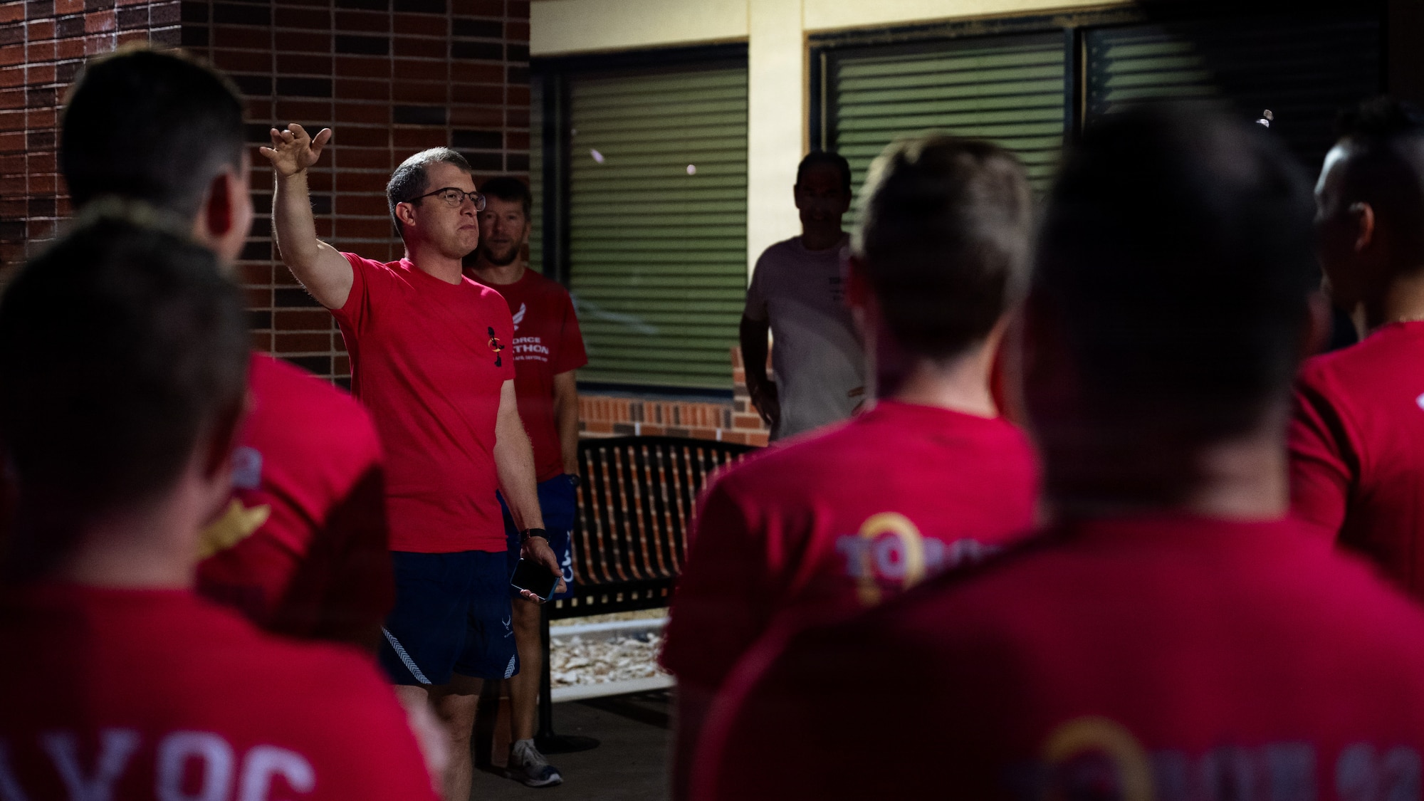 Airmen gather outside in PT gear